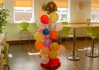 Balloon Tree™ Stand in café with balloons