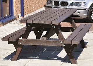 Clifton™ Recycled Material Picnic Table in brown Enviropol® Material outside a service station