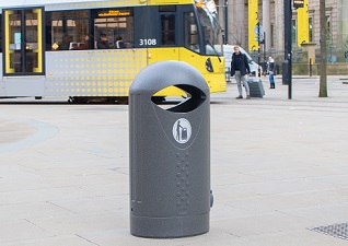 Elipsa™ Street Litter Bin in millstone at a central tram station