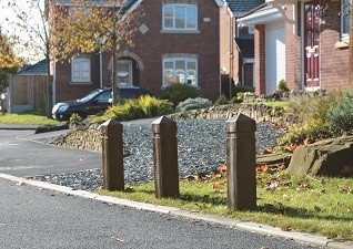 Three Glenwood Posts marking a grass verge in a residential area