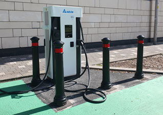 Glasdon Manchester™ Bollards installed at an EV charging point. 