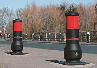 Neopolitan™ 150 600mm Reduced Height Passively Safe Bollard on highway – black with red reflective banding