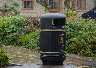 Topsy Royale™ Outdoor Litter Bin in traditional styling outside a hotel