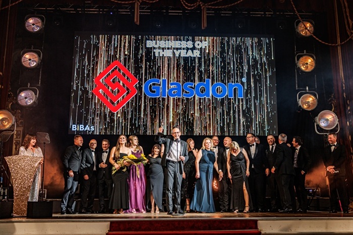 Glasdon employees accepting the award for BIBA Business of the Year on stage