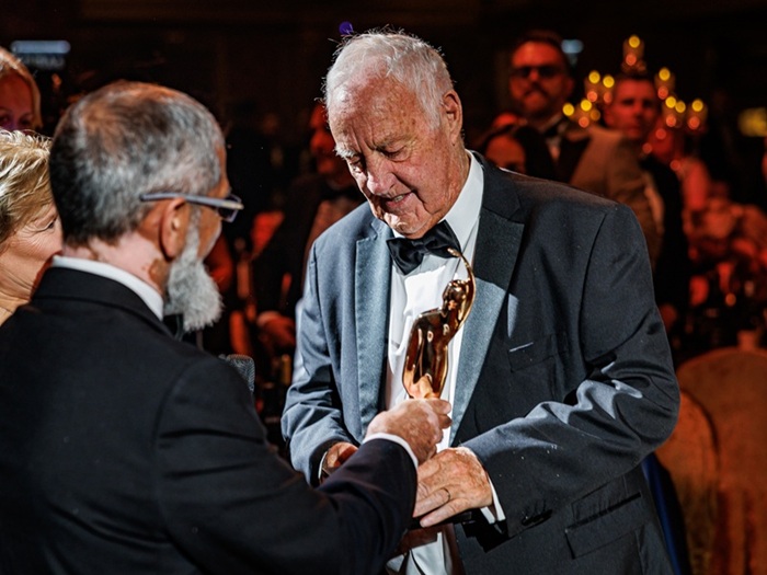 donald sidebottom accepts lancastrian of the year award on stage