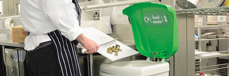 Chef disposing of food waste into a Nexus Shuttle