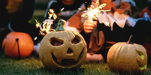 Excited children with a carved pumpkin at Halloween