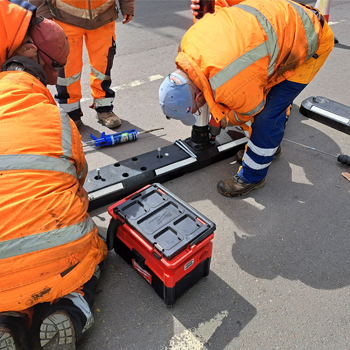 workers installing Glasdon Endurokerb cycle lane defenders on Kirkcudbright bridge