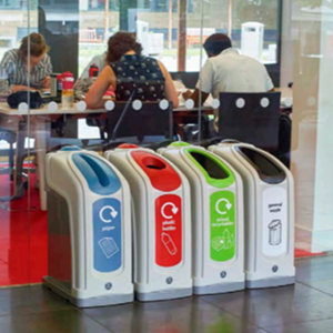 four nexus 50 recycling bins with different waste streams and apertures in an office setting