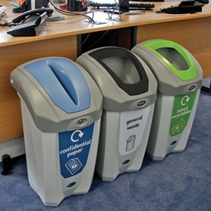 three nexus 30 bins with different waste streams and apertures in an office setting
