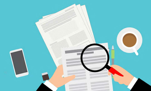 magnifying glass over pieces of paper signifying a waste management audit