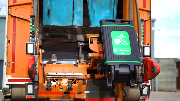 glasdon jubilee city recycling food waste bin being mechanically emptied into a waste collection vehicle