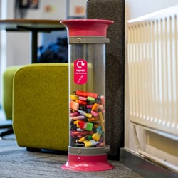 a cthru vape recycling bin half filled with vapes in a seating area