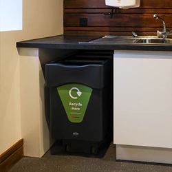 nexus caddy food waste bin with green recycling graphics tucked beneath a kitchen sink