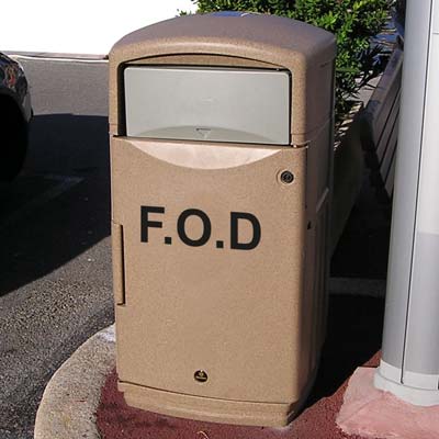 sandstone FOD 100 bin with flap in an outdoor area