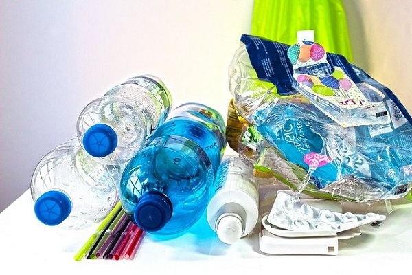 Mixture of plastics bottles and soft plastics ready for recycling