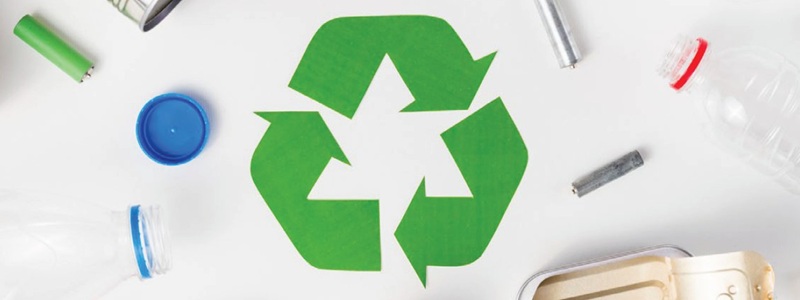 green recycling symbol surrounded by recyclable waste
