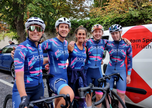 five team jadan cyclists standing together as a team on a street