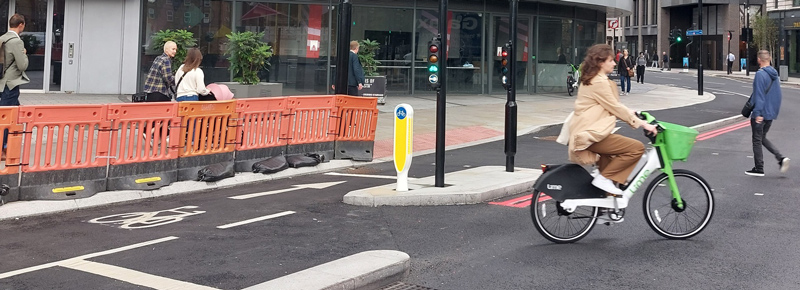 Images of socketed bollards with traffic roundabout background