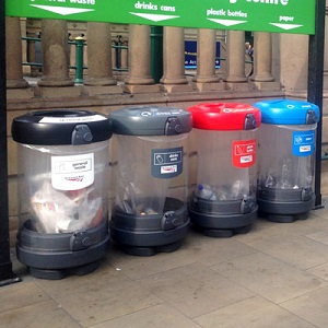 a selection of c-thru 180 recycling bins with different waste streams in a train station